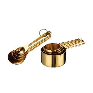 8-piece set of rose gold stainless steel measuring cups and spoons on white background