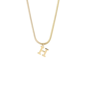 Detail of a 18K gold-plated H letter pendant on a sleek flat snake bone chain necklace