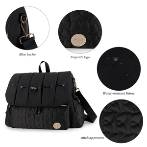 Detail of alloy buckle and exquisite logo on water-resistant black quilted diaper bag