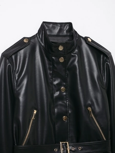 Detail einer schwarzen PU-Lederjacke mit goldenen Knöpfen, Reißverschluss und Gürtel