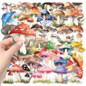 Hand holding a colorful waterproof mushroom sticker from a 50-piece PET cartoon set
