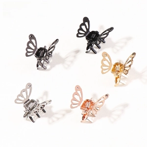 Macro shot of mini butterfly hair claws in gold, silver, and rose gold with hollow texture