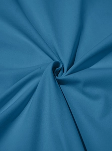 Detailed view of dark blue cotton fabric texture with soft folds and high durability