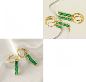 Macro detail of 18K gold plated earrings with three vertical rectangular emerald zircons