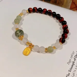 Elegant green phantom and tiger eye crystal beaded bracelet with a gold relief charm