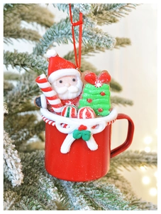 Macro detail of a red mini mug ornament with Santa Claus and festive elements