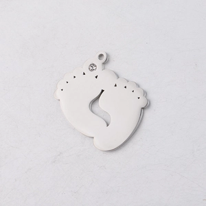 Macro shot of silver stainless steel baby footprints pendant with sparkling rhinestone