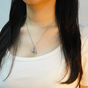 Fashion silver stainless steel bubble letter A pendant necklace on a model