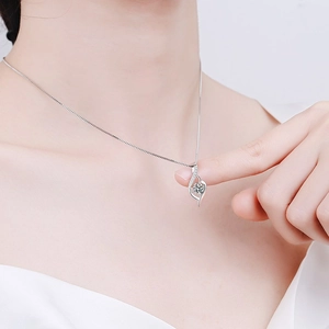 Close-up of s925 silver necklace with teardrop pendant and moissanite center stone