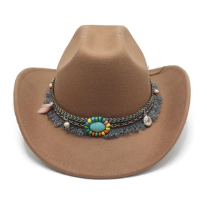 Close-up of ethnic band with turquoise stone and tassels on a brown wool cowboy hat