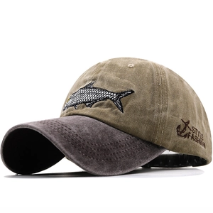Detail of embroidered fish pattern and washed cotton fabric on outdoor baseball cap