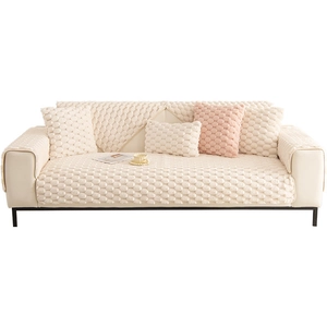 Thick beige plush sofa cover with geometric pattern and pink pillow for winter warmth