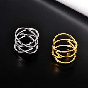 Detailed close-up of double-layer hollow criss-cross rings in gold and silver stainless steel