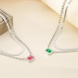 Double-layered stainless steel snake chain necklace with green and pink crystal pendants