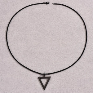Close-up of black triangle pendant with bead chain on a grey textured background