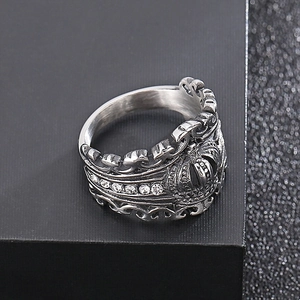 Macro shot of vintage silver crown ring with cubic zirconia stones on black background