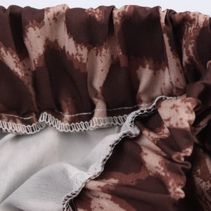 Close-up of leopard print pants featuring elastic waistband and professional stitching