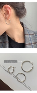 Detail of S925 sterling silver hoop earrings set showing model wear and hallmarked texture