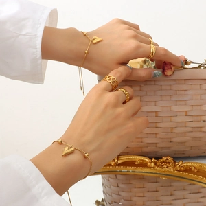 Chic gold heart pendant bracelet and stacked rings set for women in elegant setting