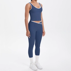 Detail of navy blue yoga set showing white contrast trim on U-neck top and V-waist leggings