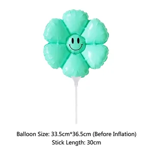 Detail of light green daisy flower balloon with smiley face and a 30cm white hand pole