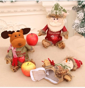 Detail of Christmas gift bags with reindeer and Santa Claus designs in warm home setting