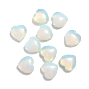 Macro shot of ten heart-shaped moonstone crystals with smooth polished blue sheen