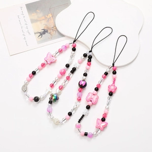 Close-up of three pink and black beaded bear phone charms with star and flower beads