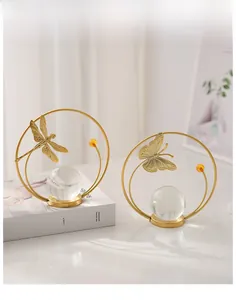 Close-up of golden iron insect ornaments with clear crystal balls on a book