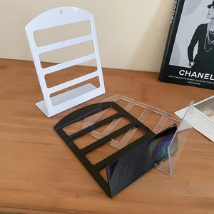 L-shaped acrylic earring holder stands in black, white and clear showing 4-tier storage