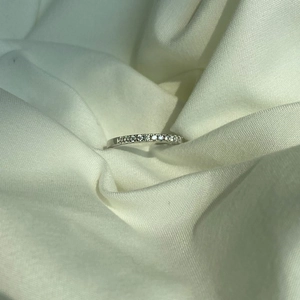 Close-up of minimalist S925 sterling silver band ring with sparkling micro-pave crystals