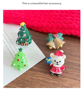 Detailed view of sparkly resin Christmas ornaments with tree, bear, and bell charms