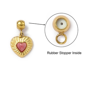 Detail of pink heart charm with gold plating and rubber stopper inside for DIY jewelry