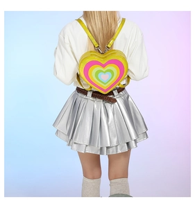 Y2K style bright yellow heart-shaped backpack with colorful gradient pattern on a model