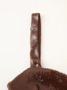 Detail of brown sequin fabric and stitching on a sexy party bodycon dress