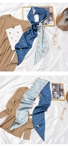 Detail of double-sided silk scarf with polka dots and rabbit pattern on lifestyle background