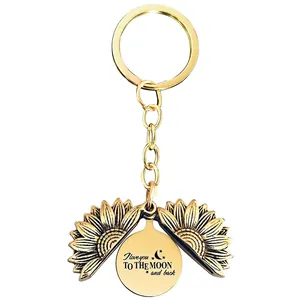 Detail of sunflower locket keychain with I love you TO THE MOON and back engraving