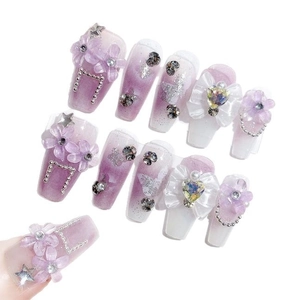 Handmade purple galaxy press-on nails with 3D iris flowers and sparkling rhinestone gems