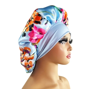 Floral print satin bonnet with wide elastic band shown on a side-view model