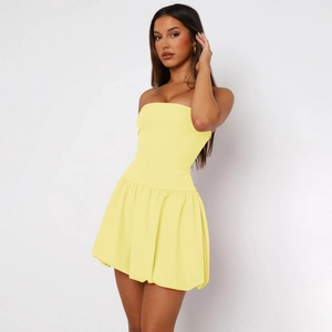 Detail view of a slim fit pale yellow tube dress with high-elastic fabric texture