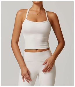 Detail of white cross-back yoga tank top showing delicate seams and soft brushed fabric