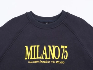 Detail of navy sweatshirt neck and yellow Milano 75 print on cotton fabric