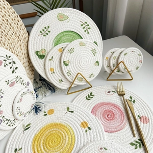 Handwoven round cotton rope placemats with avocado, lemon, and floral patterns
