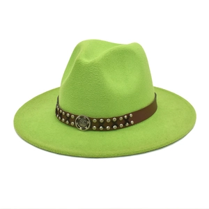 Detail of wool fedora with neon green felt texture and studded leather band decor