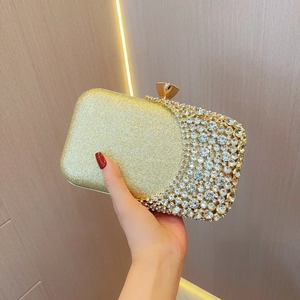 Detail of luxury gold rhinestone clutch bag with sparkling sequins and gem closure