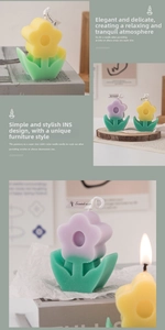 Detail view of flower-shaped scented candles in purple and yellow on green leaf bases