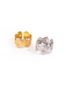 Detail of gold and silver hollow butterfly rings showing textured brushed stainless steel