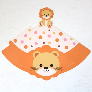 Flat lay of an unassembled paper party hat with a cute cartoon lion and colorful dots