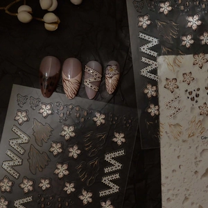 Modern leopard print nail stickers set with floral patterns and gold wavy line accents