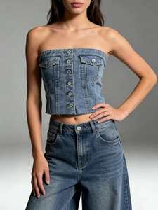 Detail of blue denim tube top featuring front metal buttons and frayed raw hem edges